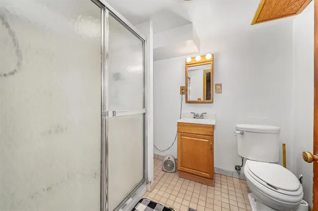 a bathroom with a toilet and a shower