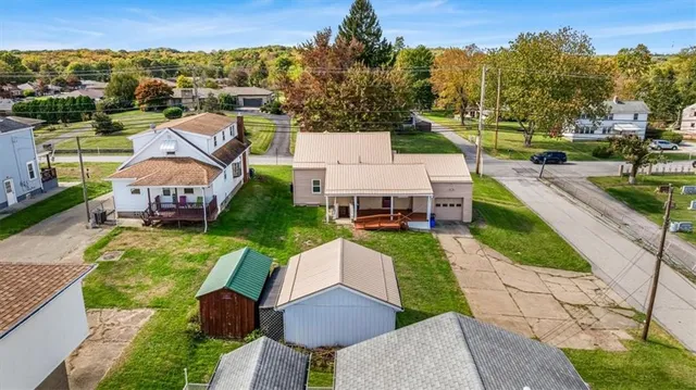 an aerial view of a house with garden space and street view