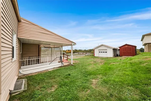 a view of house with backyard