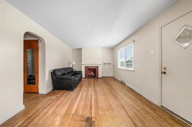 a view of a room with wooden floor air conditioner and windows