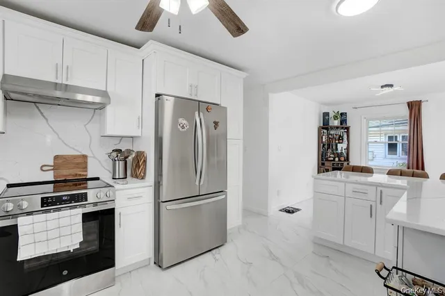 a kitchen with a refrigerator sink and cabinets