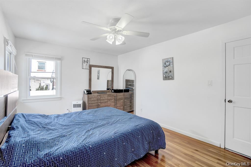 61 South Merrick Road Massapequa, NY 11758 - Photo 18 of 29 Bedroom with wood finished floors and ceiling fan