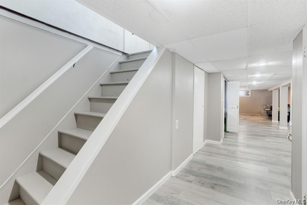61 South Merrick Road Massapequa, NY 11758 - Photo 24 of 29 Staircase with wood finished floors and a drop ceiling
