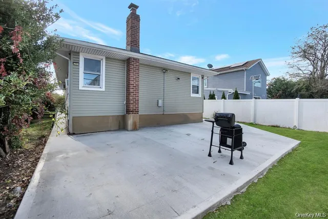 a view of a backyard with furniture and a backyard