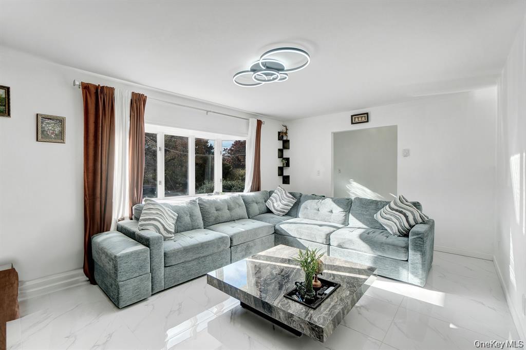 61 South Merrick Road Massapequa, NY 11758 - Photo 4 of 29 Living room with light marble finish floors and baseboards