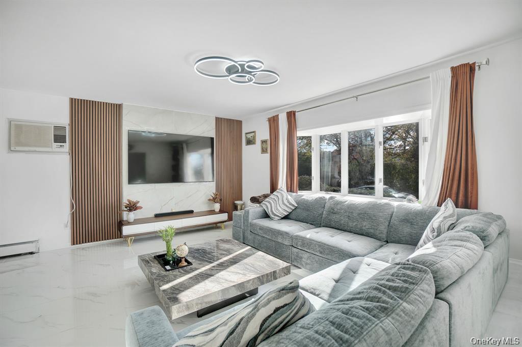 61 South Merrick Road Massapequa, NY 11758 - Photo 5 of 29 Living area featuring a wall unit AC