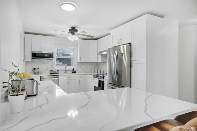a kitchen with refrigerator and cabinets