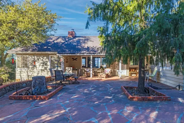 a view of a house with backyard porch and sitting area