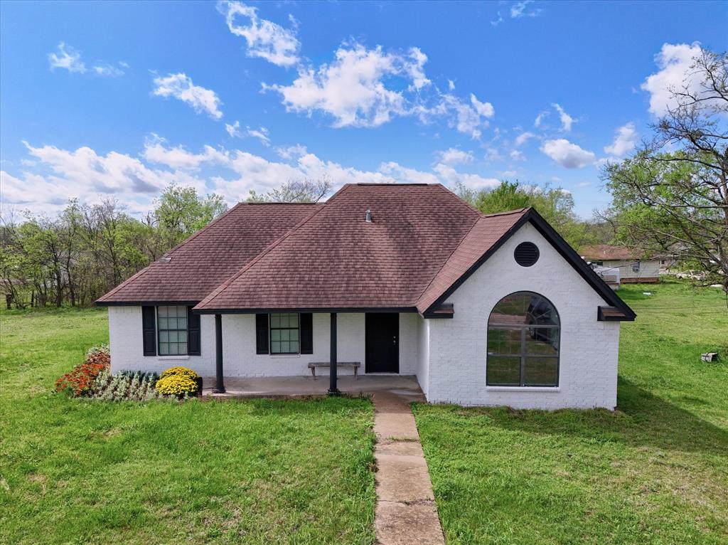 308 South Herman Street Mexia, TX 76667 - Photo 1 of 28 a front view of a house with garden