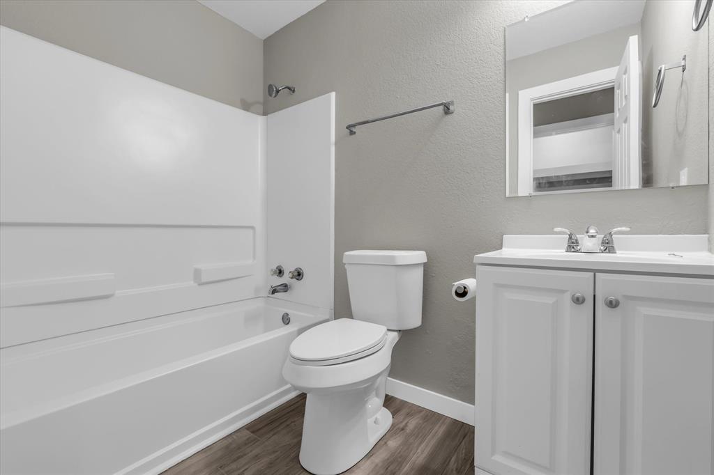 308 South Herman Street Mexia, TX 76667 - Photo 14 of 28 a bathroom with a toilet sink and a bathtub