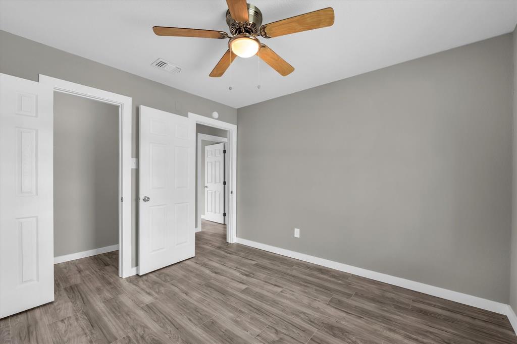308 South Herman Street Mexia, TX 76667 - Photo 18 of 28 an empty room with wooden floor and windows