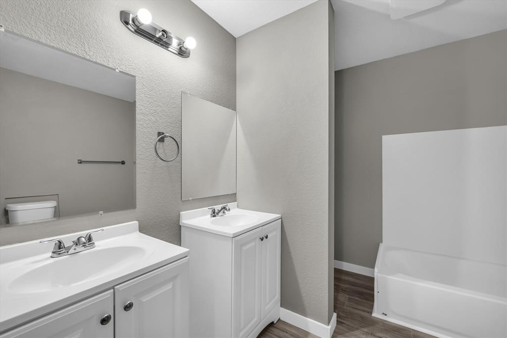 308 South Herman Street Mexia, TX 76667 - Photo 23 of 28 a bathroom with a sink a toilet and shower