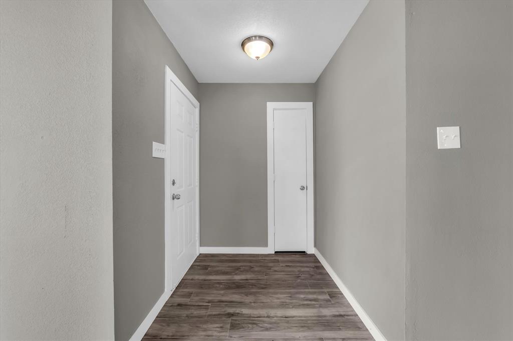 308 South Herman Street Mexia, TX 76667 - Photo 6 of 28 a view of a hallway with wooden floor