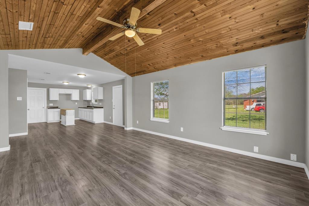 308 South Herman Street Mexia, TX 76667 - Photo 8 of 28 a view of an empty room with wooden floor and a window