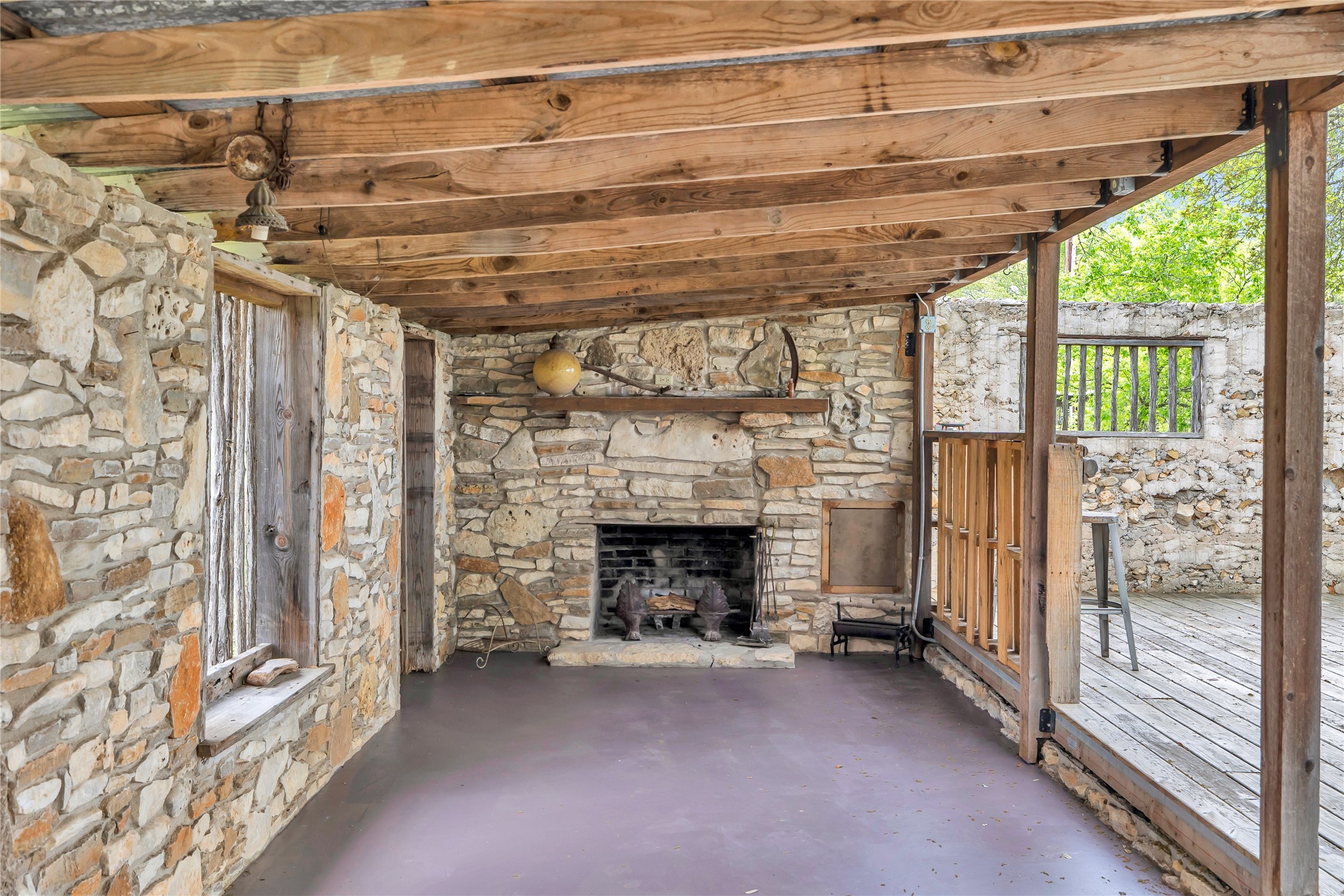 123 Rocky Road Hye, TX 78635 - Photo 15 of 40 Open-air patio with fireplace.
