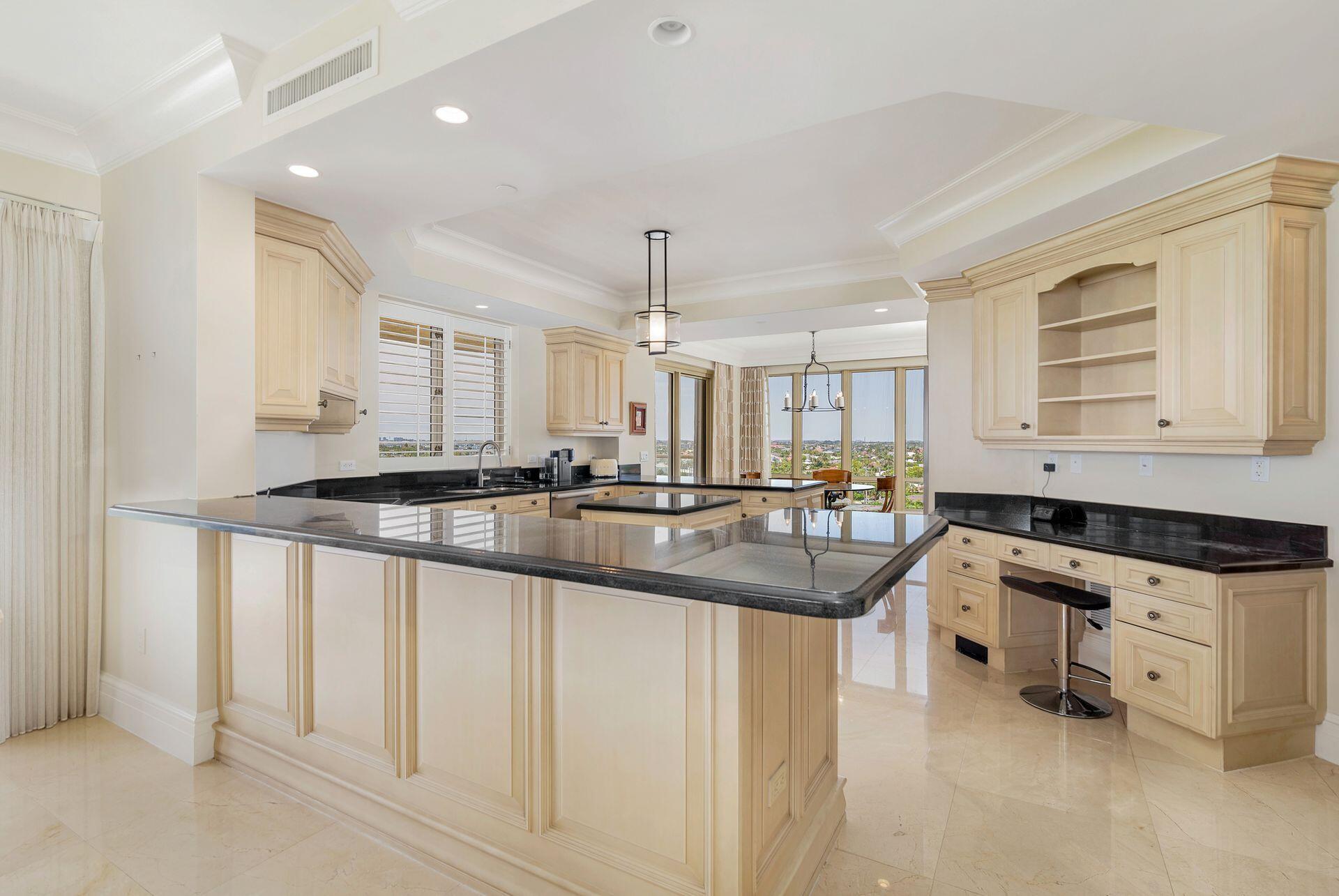 3920 North Ocean Drive, Unit 7A Singer Island, FL 33404 - Photo 11 of 35 a kitchen with stainless steel appliances granite countertop a sink and cabinets