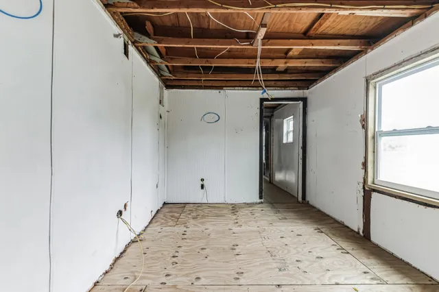 a view of hallway with wooden floor