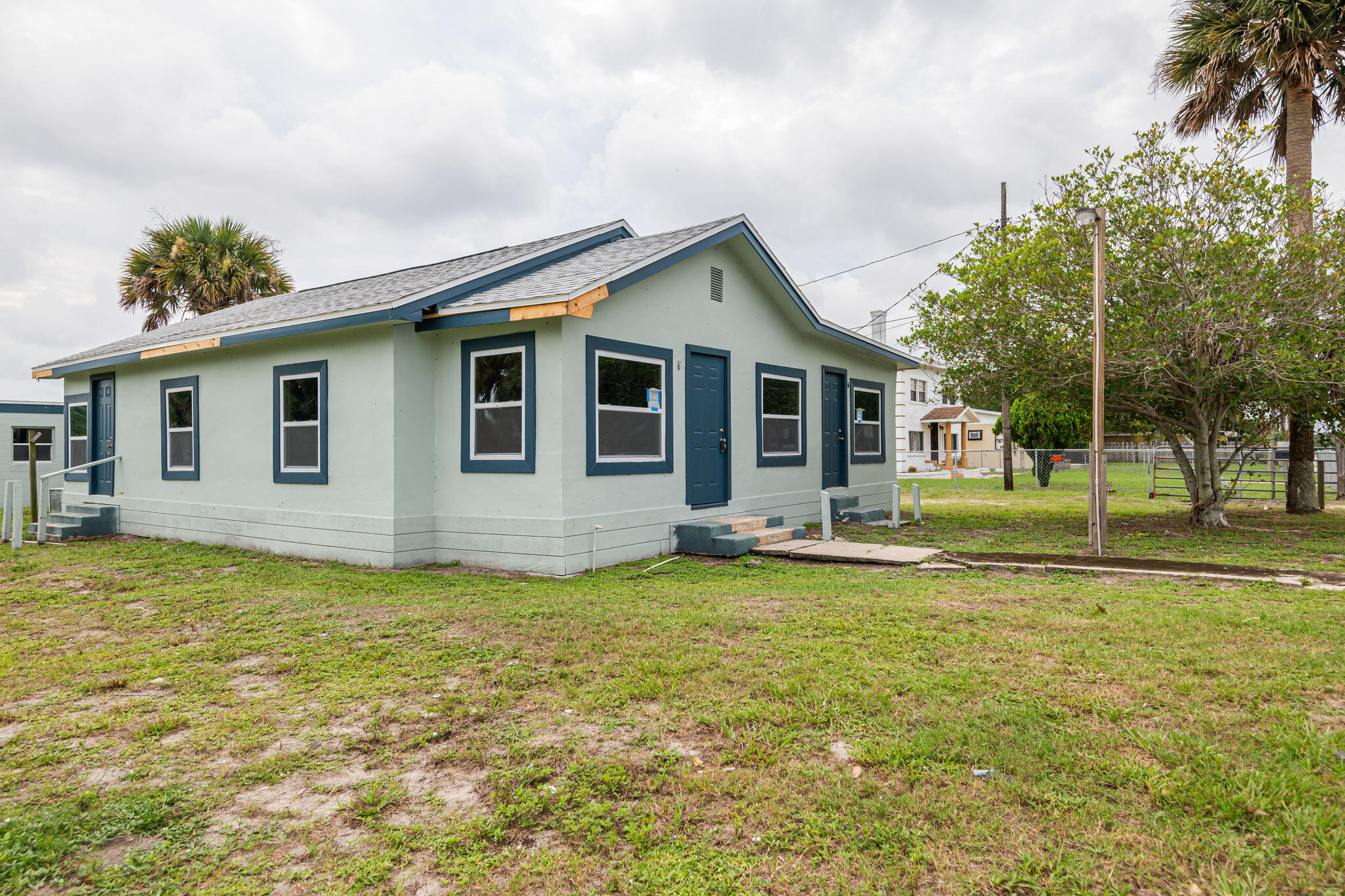 2511 Lipscomb Street Melbourne, FL 32901 - Photo 2 of 30 a view of a house with a big yard and potted plants