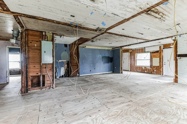 a view of a livingroom with wooden floor and a entryway