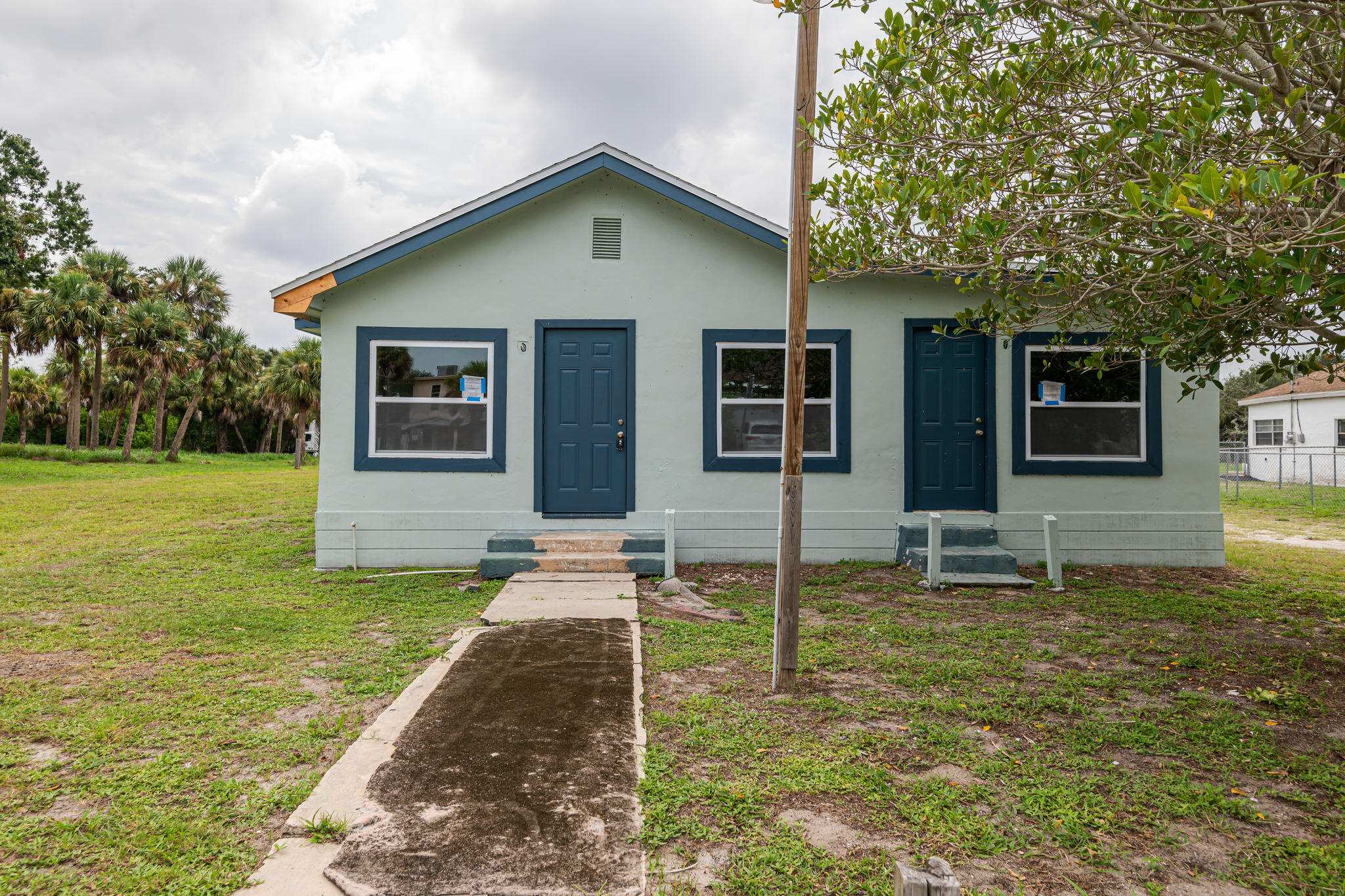 2511 Lipscomb Street Melbourne, FL 32901 - Photo 3 of 30 a front view of a house with a yard