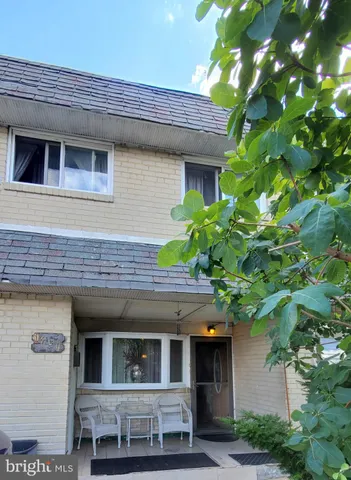 a view of house with a tree