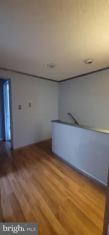 a view of hallway with a kitchen