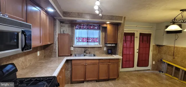 a kitchen with stainless steel appliances granite countertop a stove and a sink