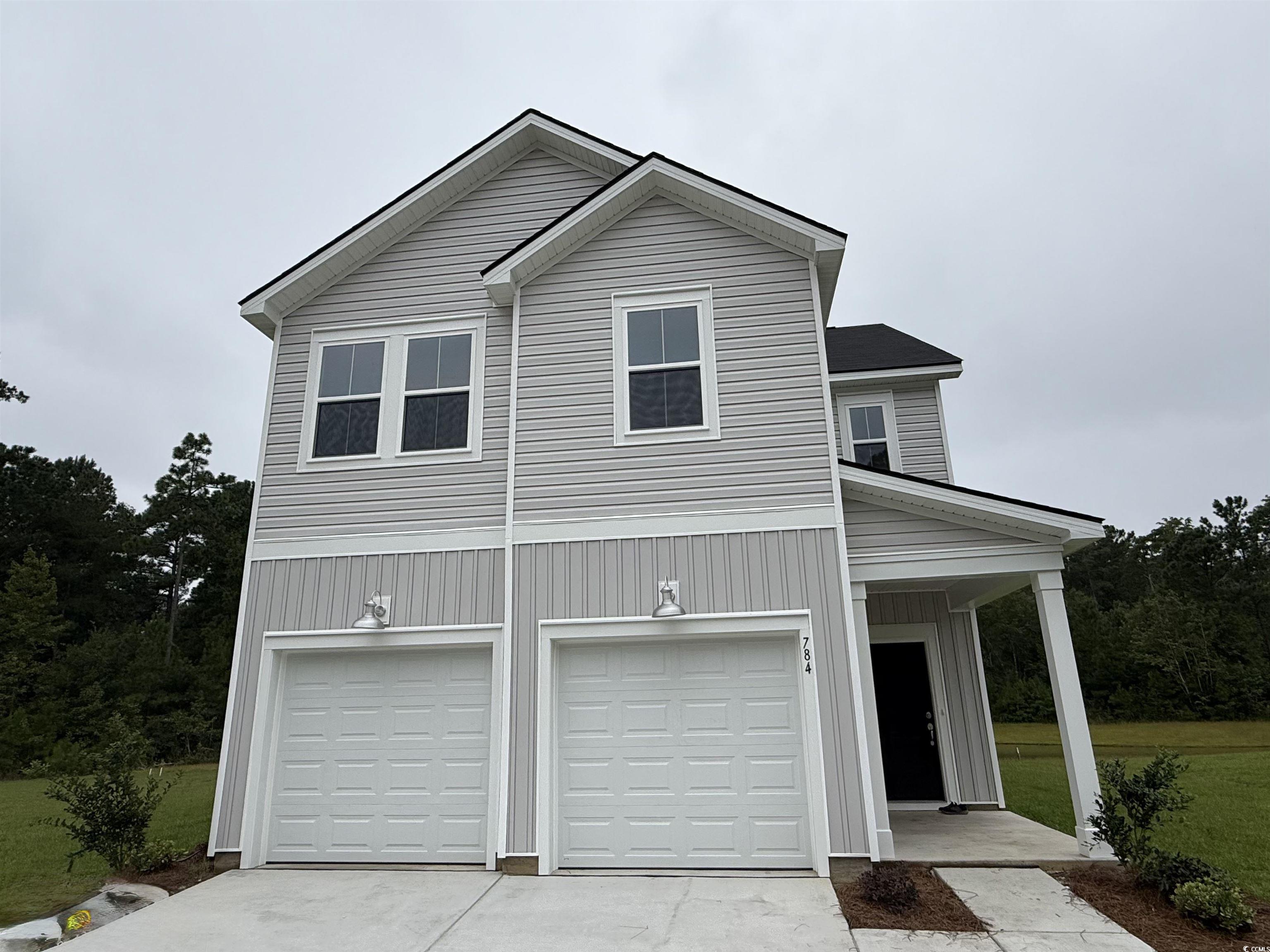 784 Sturdy Root Place Myrtle Beach, SC 29588 - Photo 1 of 19 View of front facade featuring driveway, covered p