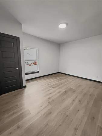a view of an empty room and wooden floor