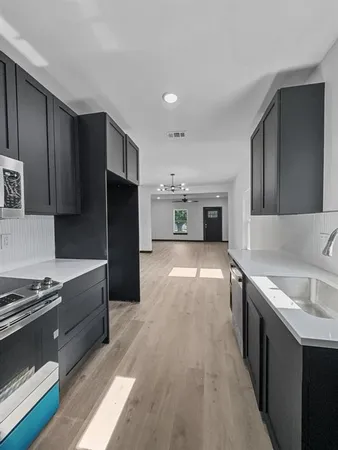 a kitchen with stainless steel appliances granite countertop a refrigerator and a stove top oven
