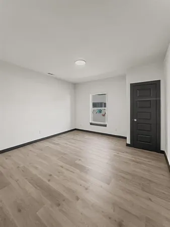 a view of an empty room with a closet
