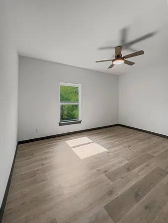wooden floor in an empty room with a window