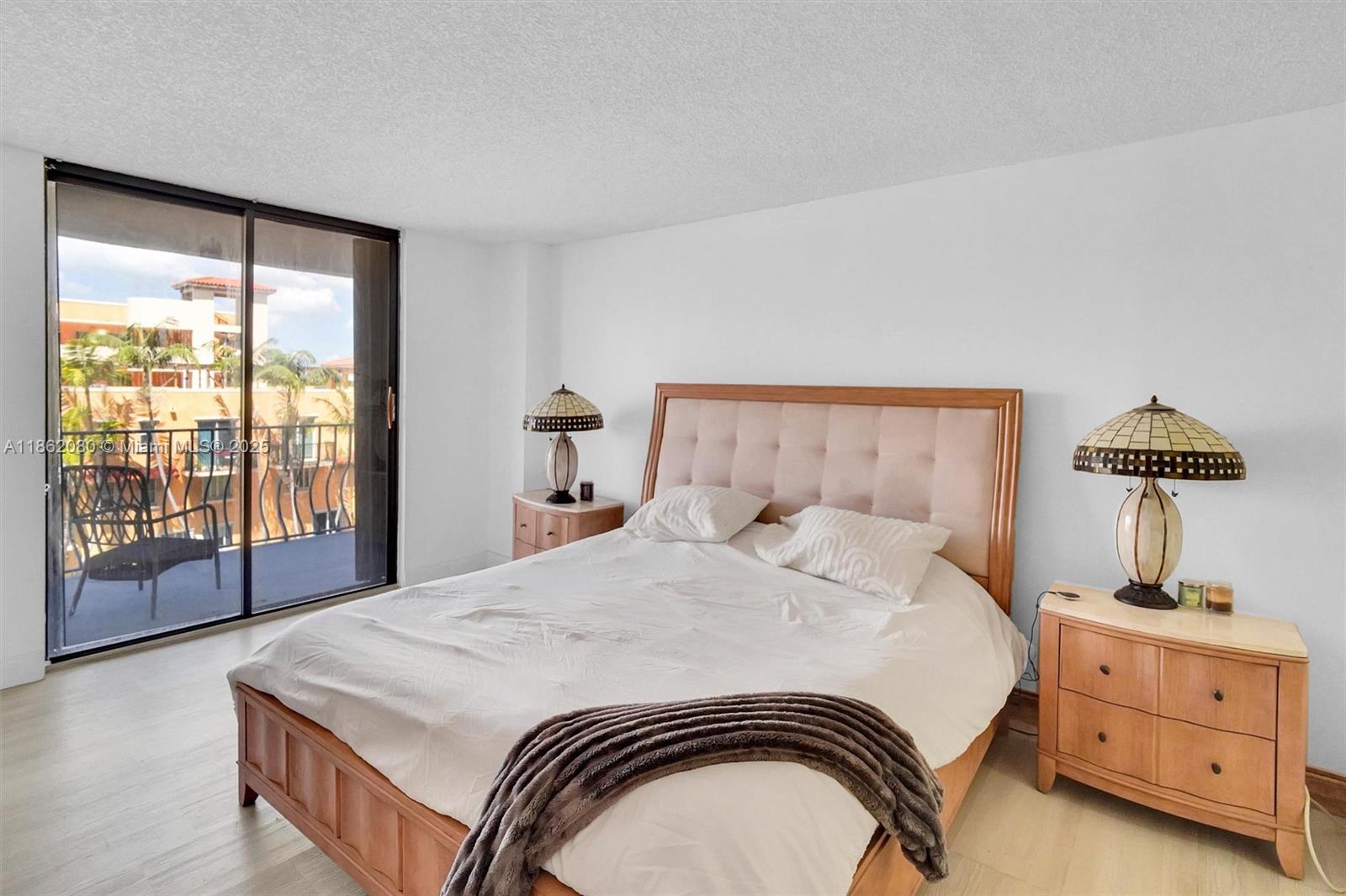 8877 Collins Avenue, Unit 405 Surfside, FL 33154 - Photo 15 of 21 a bedroom with a bed and a window