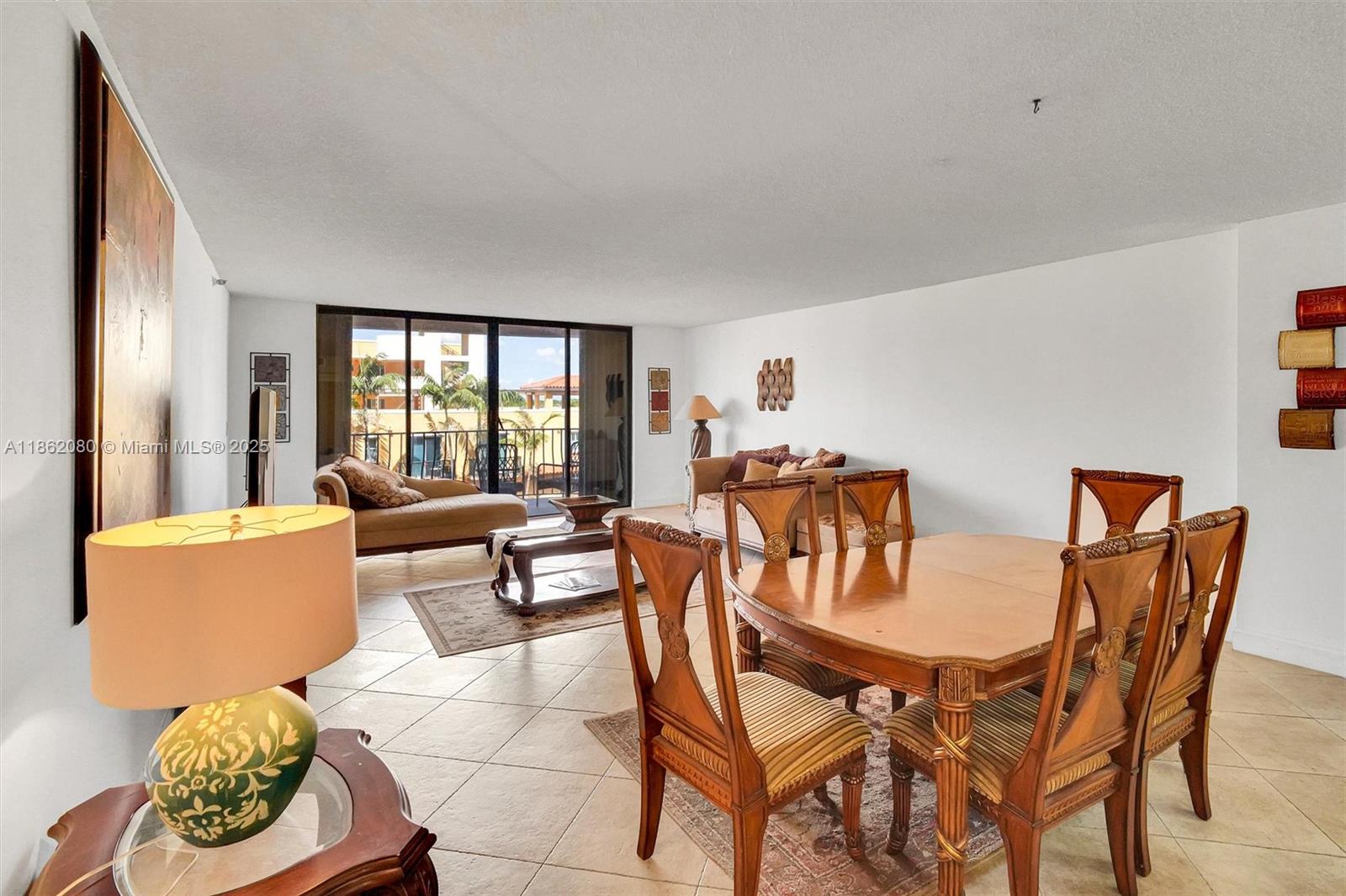 8877 Collins Avenue, Unit 405 Surfside, FL 33154 - Photo 4 of 21 a dining room with furniture and a large window