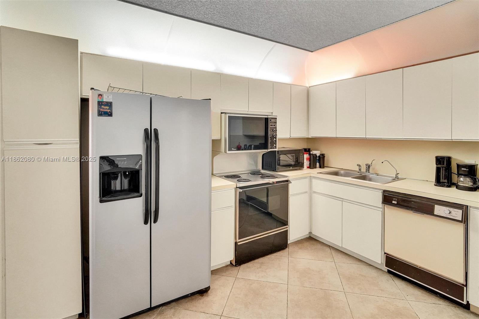 8877 Collins Avenue, Unit 405 Surfside, FL 33154 - Photo 8 of 21 a kitchen with stainless steel appliances granite countertop a refrigerator sink and stove