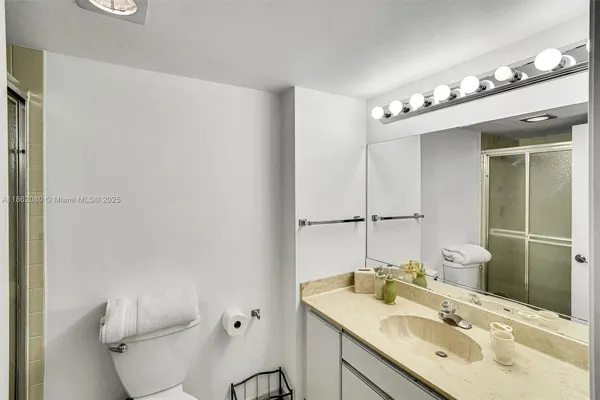 a bathroom with a sink toilet and mirror