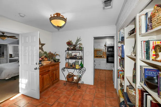 a view of living room with furniture and book shelf