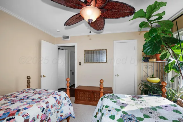 a bedroom with bed and a potted plant