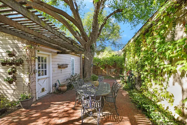 a view of a patio with table and chairs and potted plants