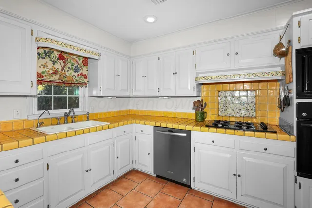 a view of a kitchen with microwave and sink