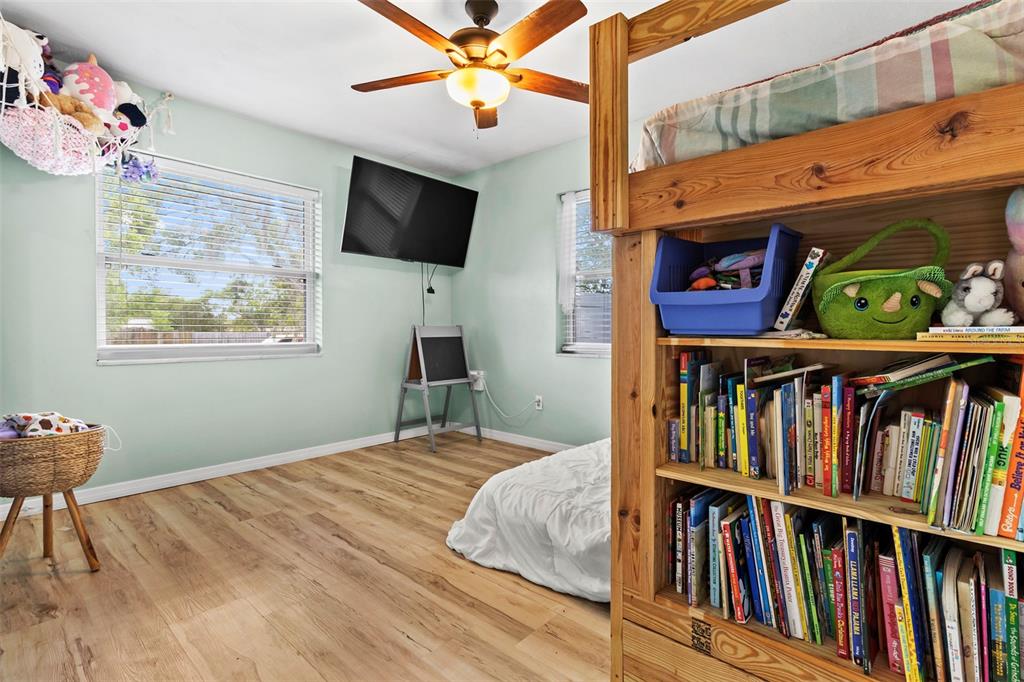 6221 Dalton Street Spring Hill, FL 34606 - Photo 18 of 40 a bedroom with furniture book shelf and a window
