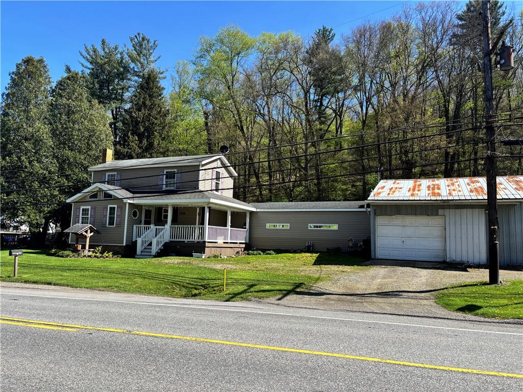 a view of a house with a garden and trees