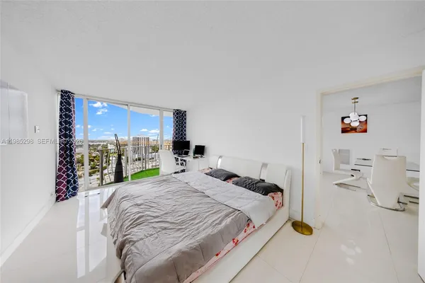 a bedroom with a bed window and table