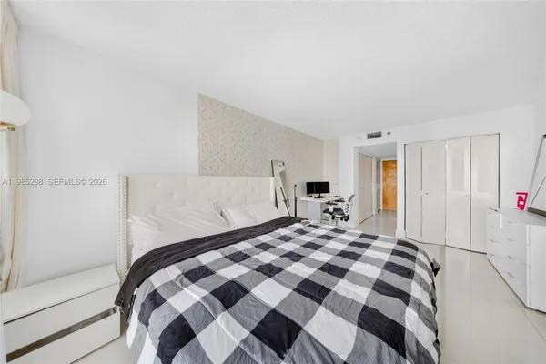 a bedroom with a bed and a walk in closet