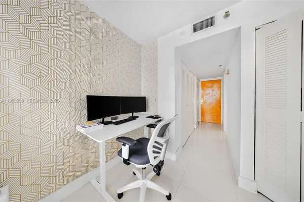 a view of a workspace with a flat screen tv