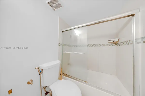 a bathroom with a shower and a toilet