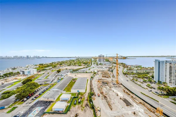 an aerial view of residential building and ocean view