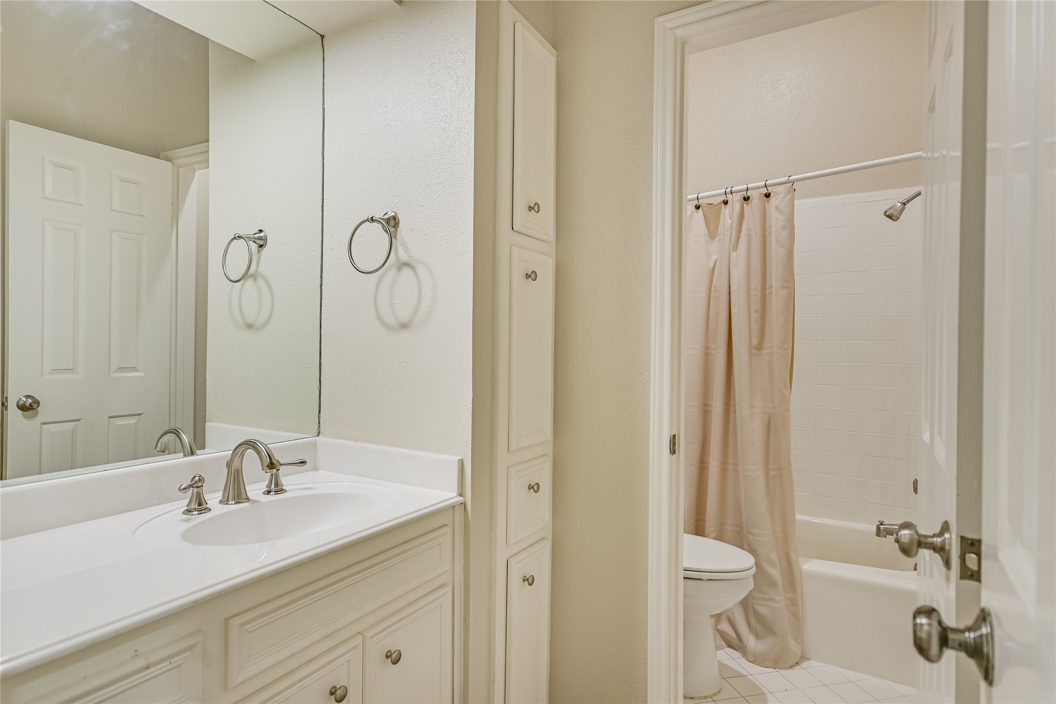 1502 West 5th Street, Unit H2 Austin, TX 78703 - Photo 11 of 17 a bathroom with a granite countertop sink a toilet and a shower