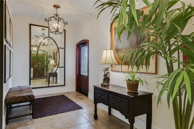 a living room with a couch and potted plant