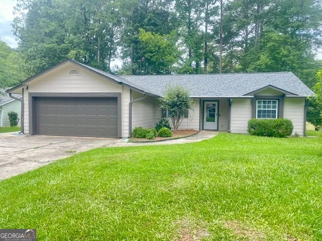 a front view of house with yard and green space